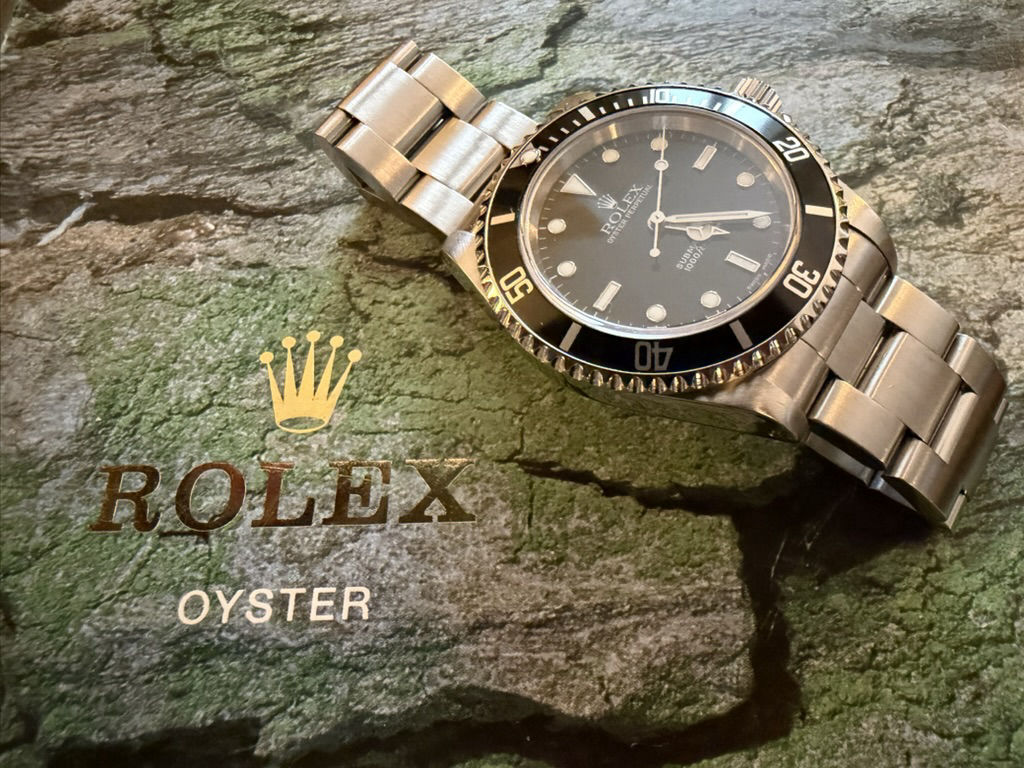 A 2003 Rolex Submariner 14060M resting on weathered stone